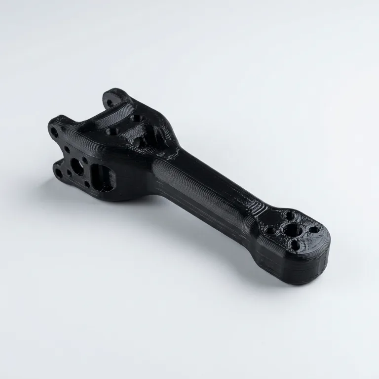Black 3D printed polycarbonate control arm link with bolt holes at both ends
